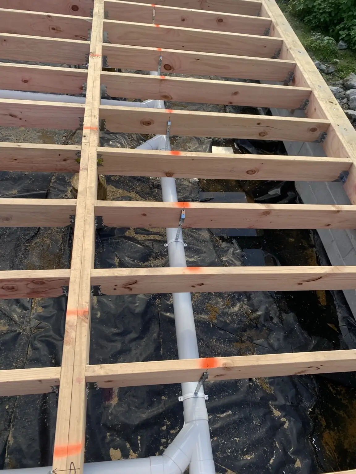 New drainage pipework run under a timber floor