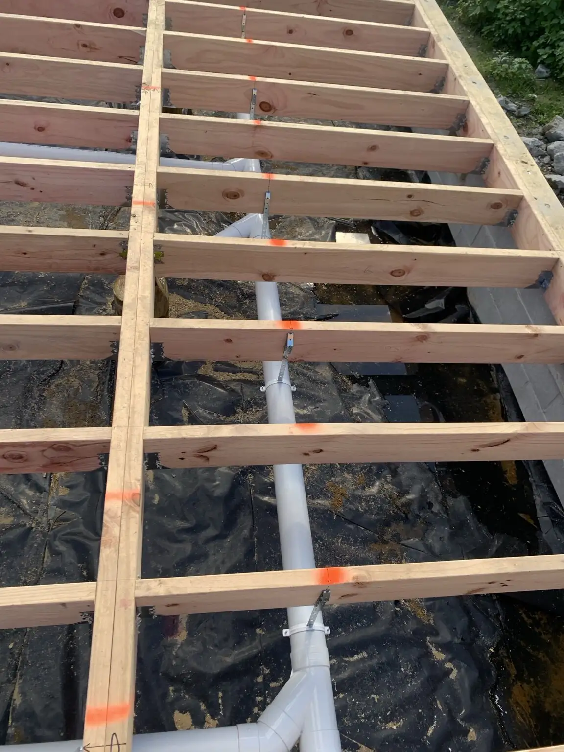 Drainage pipework run under a timber floor