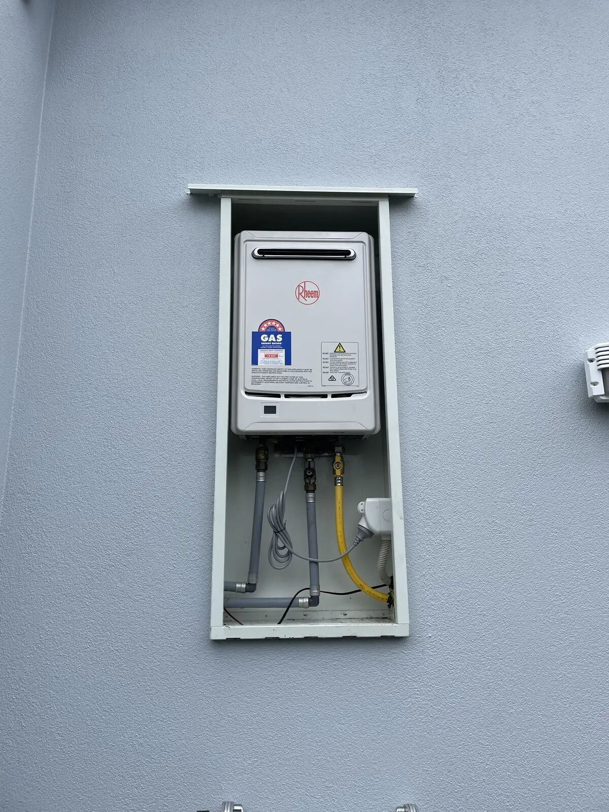 Rheem continuous flow unit on a grey wall