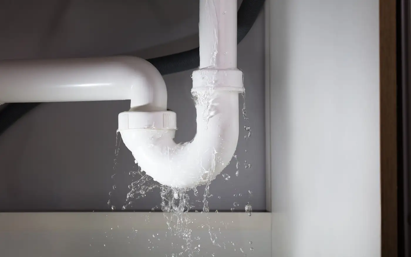 Leaking waste trap under a kitchen sink