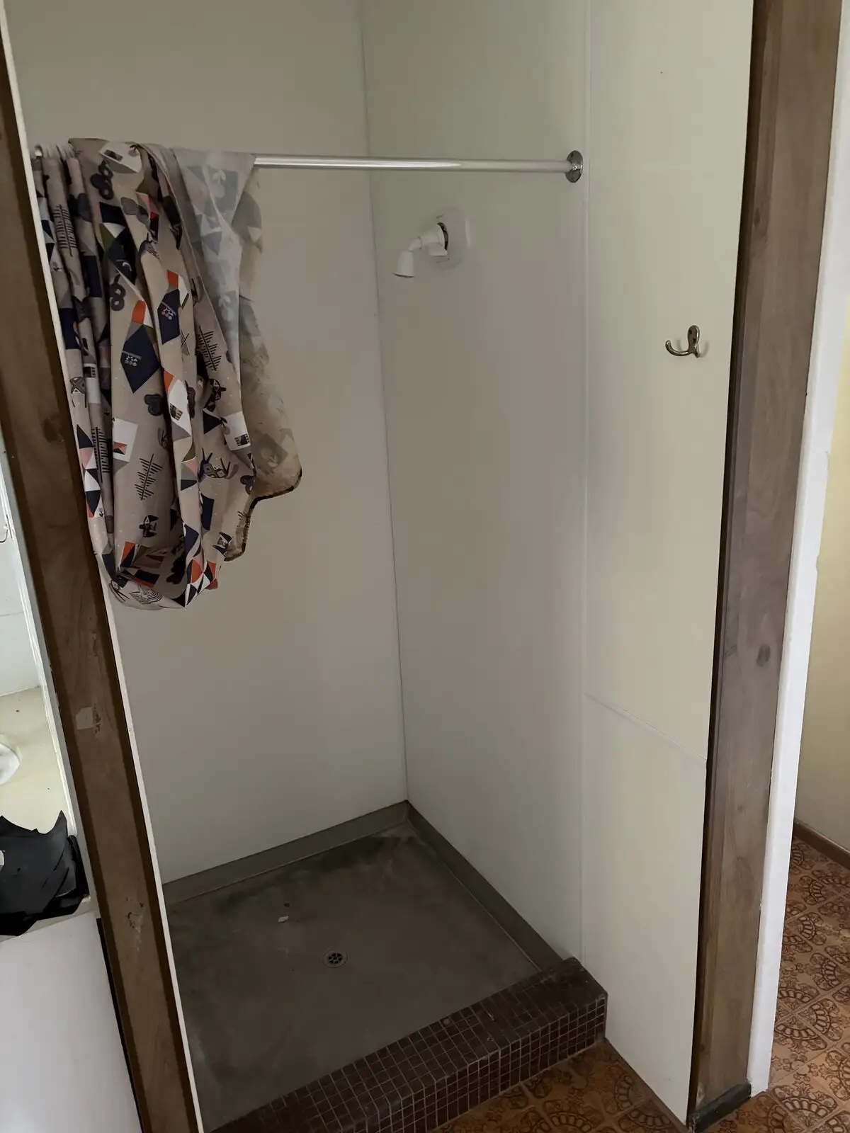 Before: old shower cubicle with a concrete tray