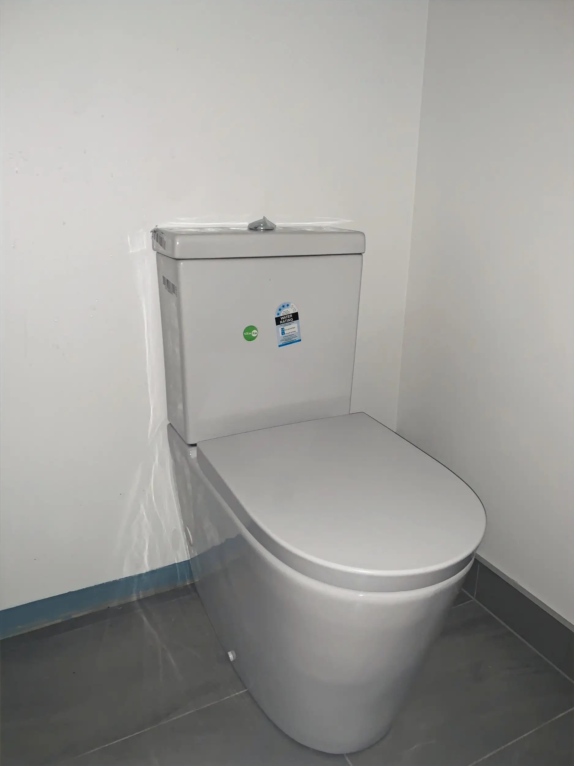 New wall-faced toilet in a white bathroom